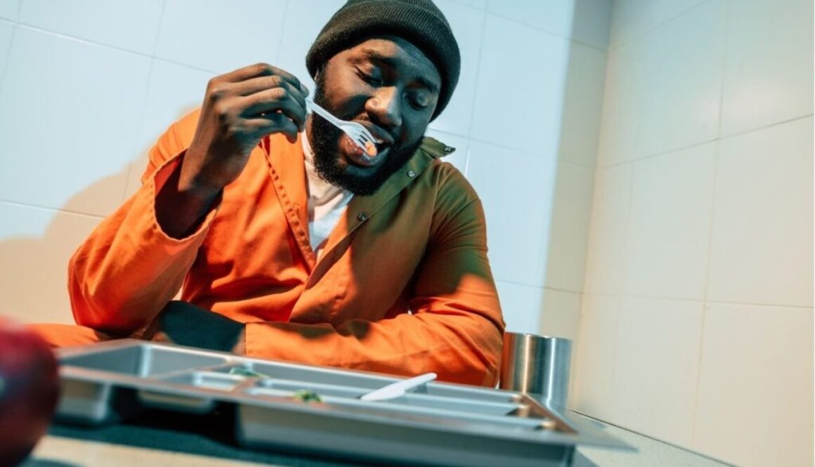 Black inmate eating his food at the prison