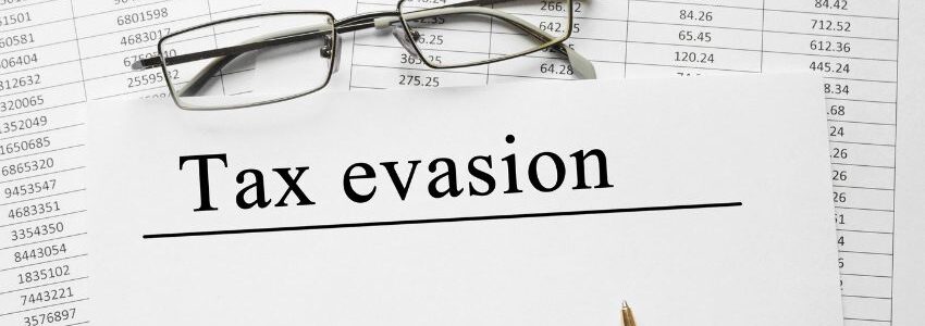 A paper with the words tax evasion written on it.