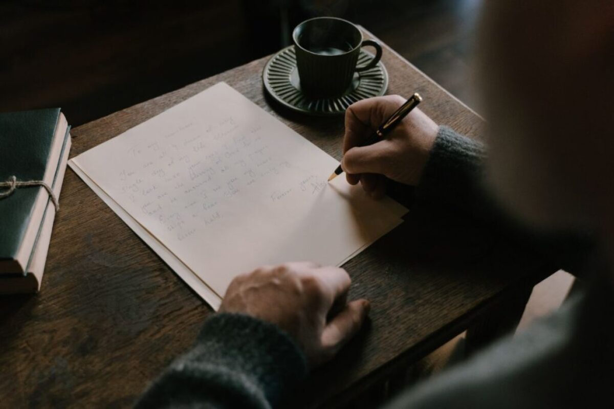 Someone writing a letter of encouragement for prisoners.