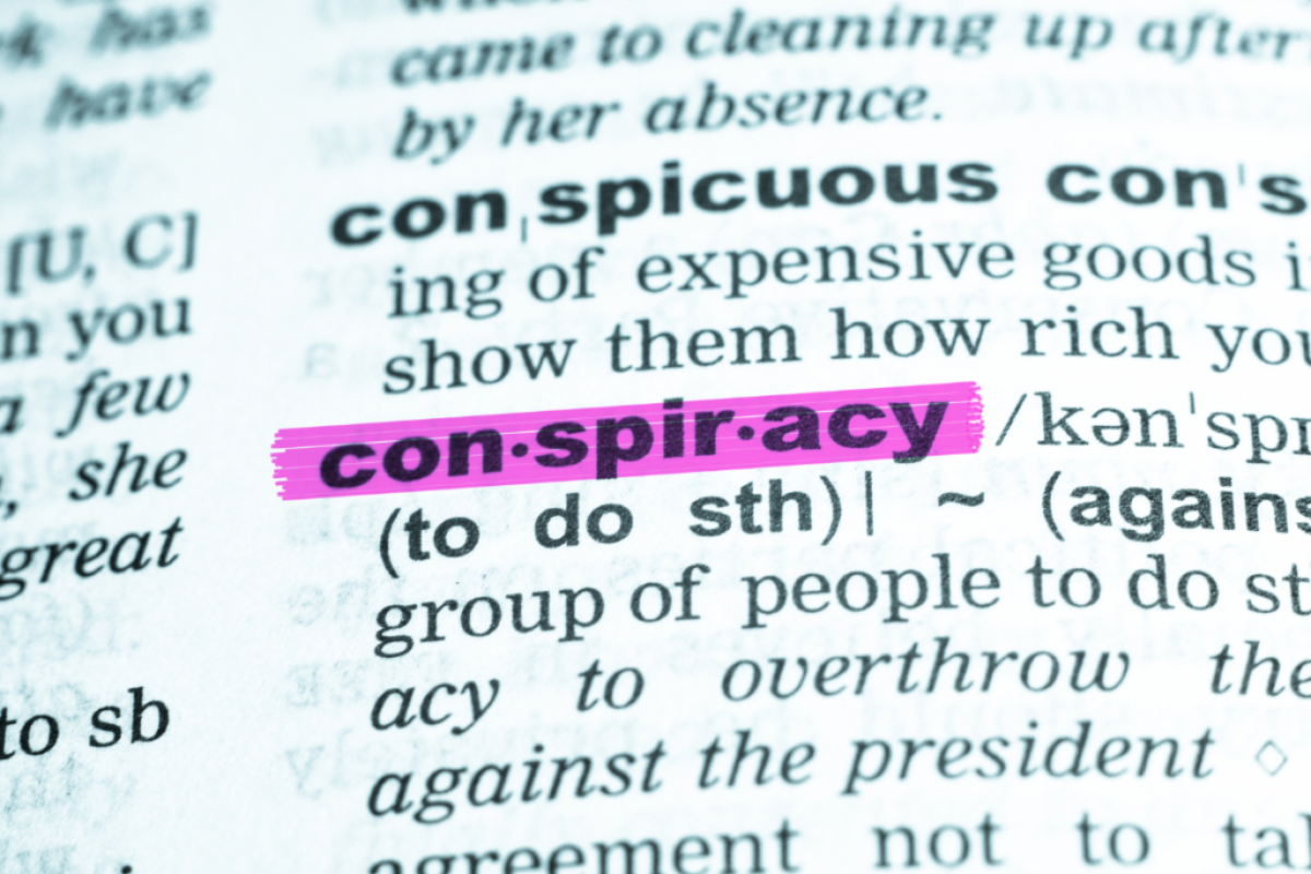 A page from a dictionary with the word conspiracy highlighted.