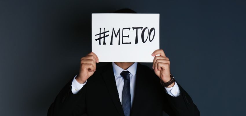 A person holding a card with a message saying he is from #MeToo movement.