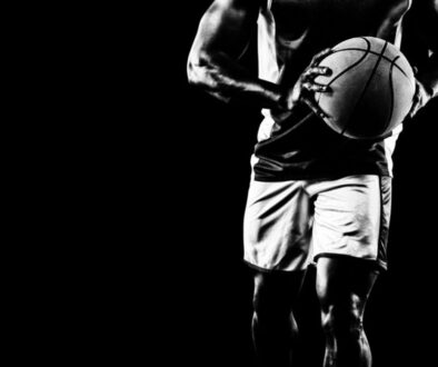 A black and white photo of a man holding a basketball ball